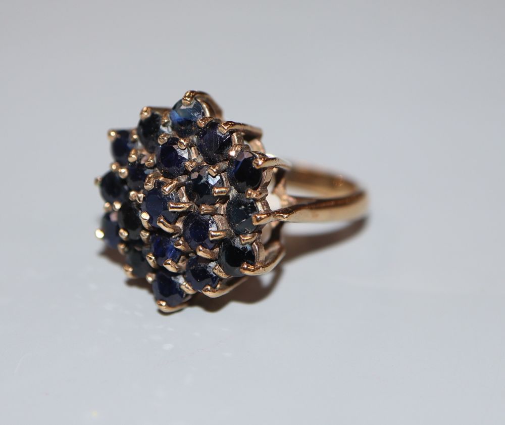 A modern 9ct gold and sapphire cluster dress ring, size M, gross 5.2 grams.